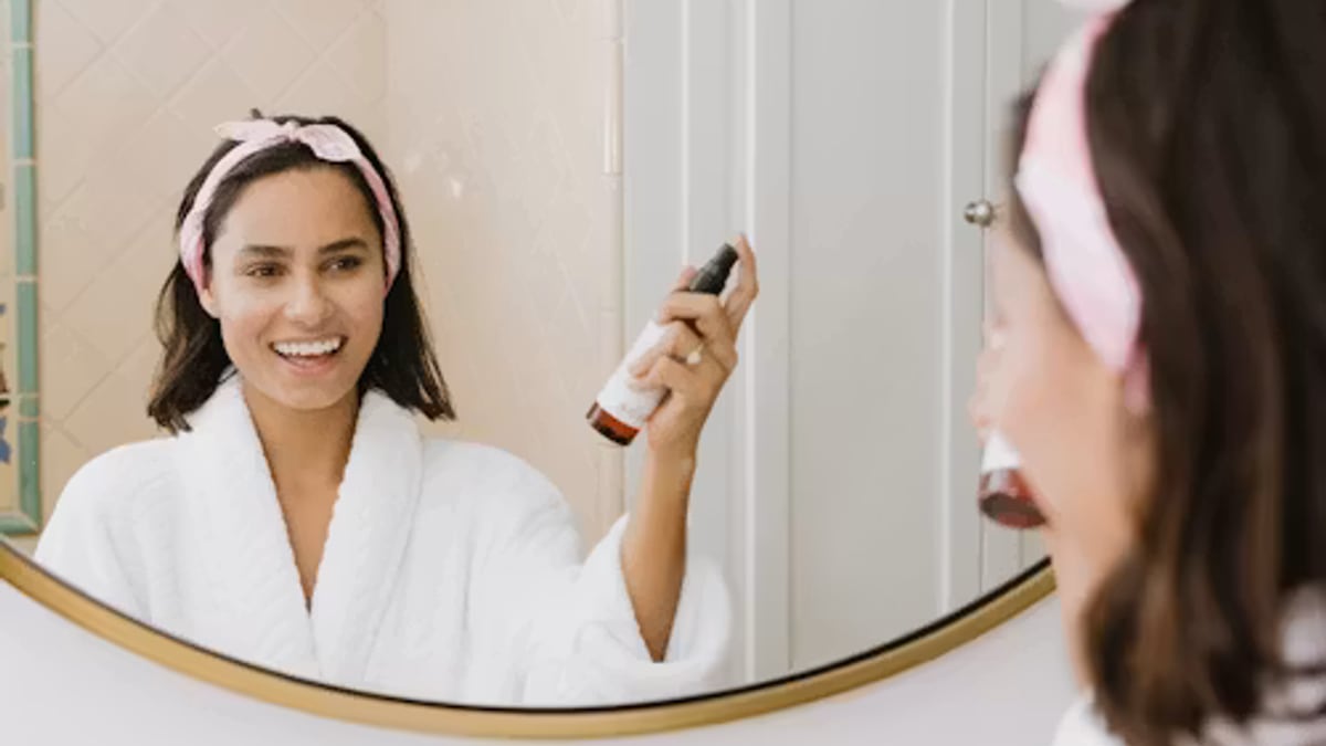 person drying hair shared bathroom morning in an everyday setting