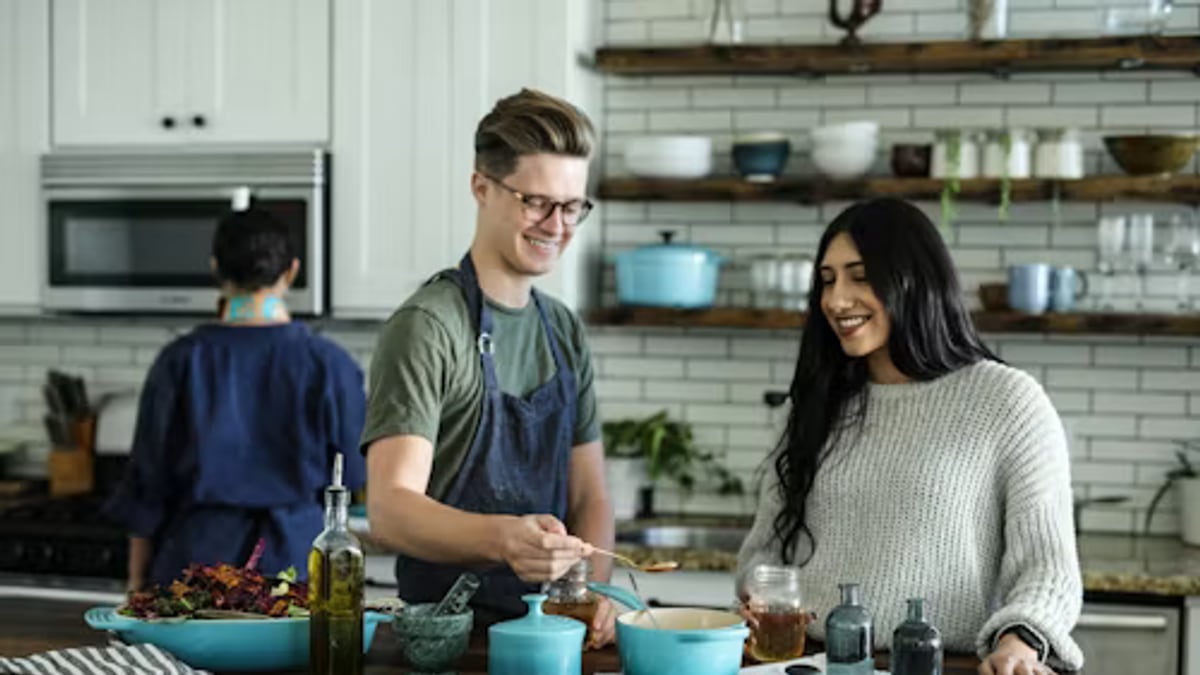 friends making tea electric kettle kitchen in an everyday setting