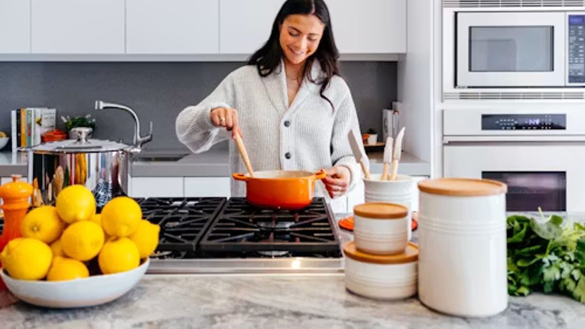 couple cooking dinner skillet kitchen in an everyday setting