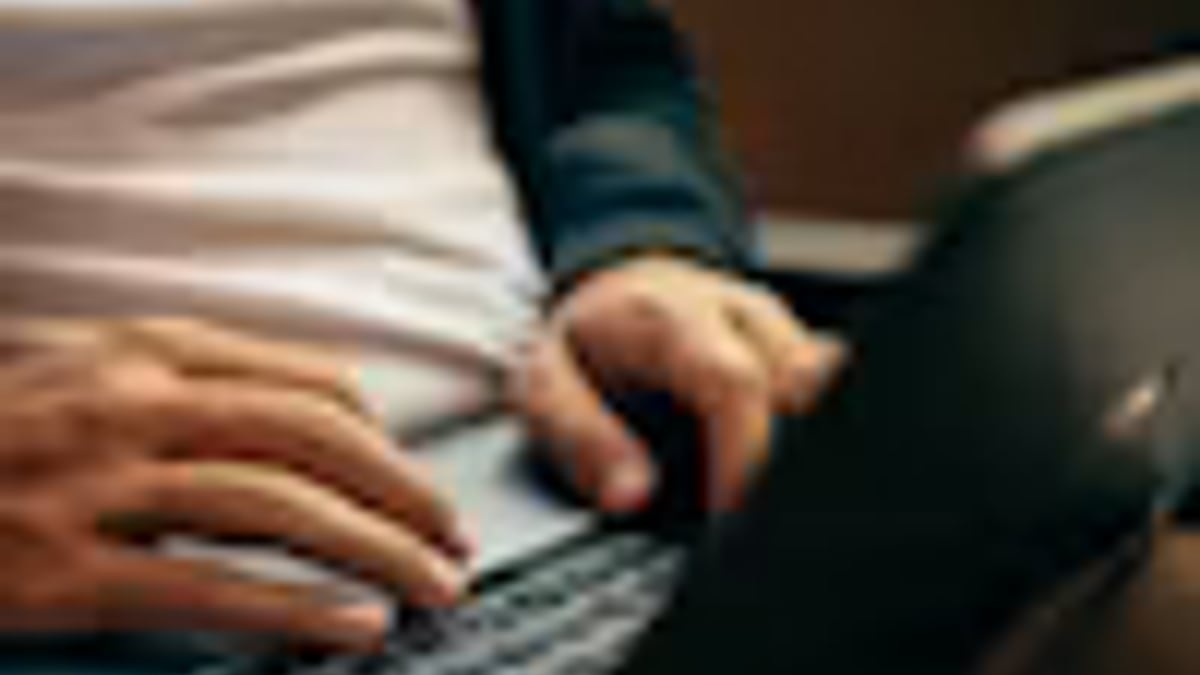 person laptop small kitchen table work in an everyday setting